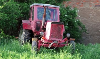 view on old tractors in a rural scene by daylight clipart