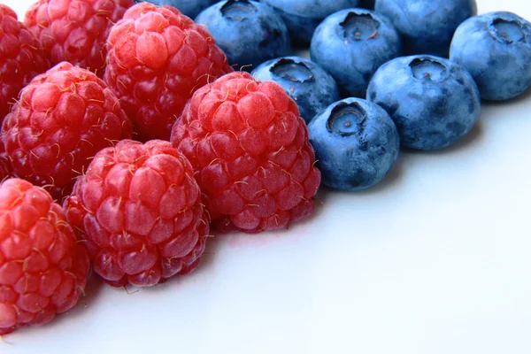 Closeup of a bunch of raspberries and blueberries — Stock Photo, Image