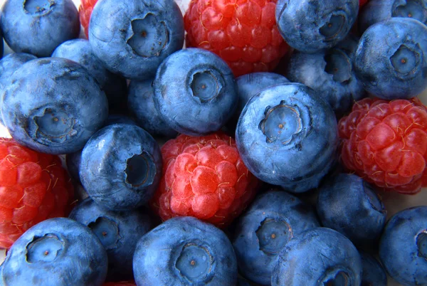 Closeup of a bunch of raspberries and blueberries — Stock Photo, Image