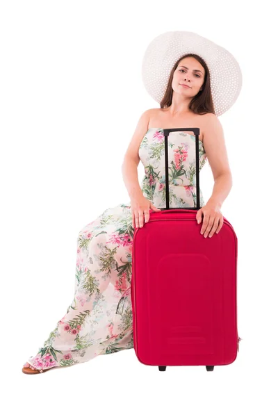 A woman in a dress on a white background A red suitcase — Stock Photo, Image