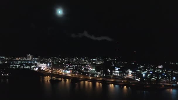 Awesome drone shot of a smoking chimney in Helsinki on a moonlit night. — стокове відео