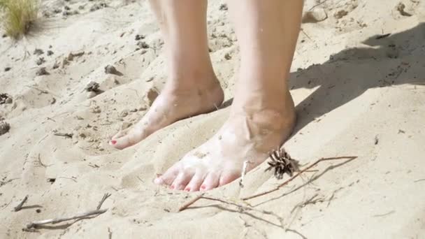 The feet on the hot white sand of the beach.4K — Video