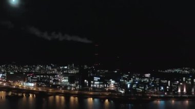 Beautiful aerial shot of a smoking chimney in Helsinki on a moonlit night.mov