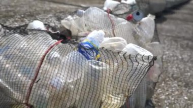Japonya 'da Koijigahama Sahili' ndeki ağ torbasına konulan plastik şişeler.