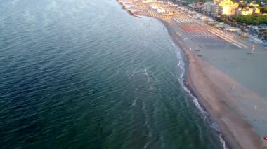 The small splashing of water in the beach shore in Rimini Italy
