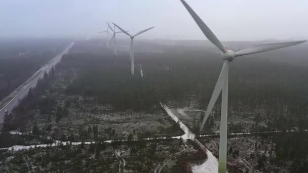 Dichterbij drone shot van windgeneratoren in Finland tijdens een mistige dag. — Stockvideo