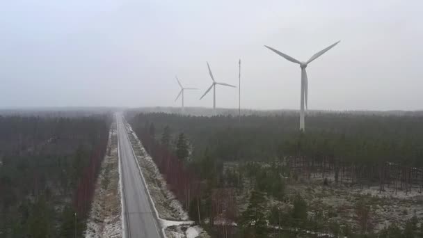 Amazing drone shot of wind generators next to a road in Finland. — Stock Video