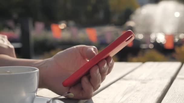 Mirada más cercana del teléfono rojo de la señora en la ciudad de Imatra.4k — Vídeo de stock