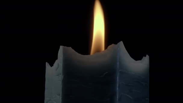 Closeup shot of a dark blue candle burning while rotating. — Stock Video