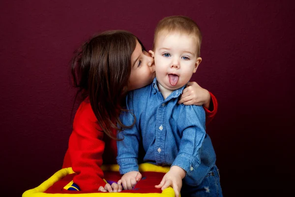 Girl Kisses Younger Brother on Cheek — Stock Photo, Image