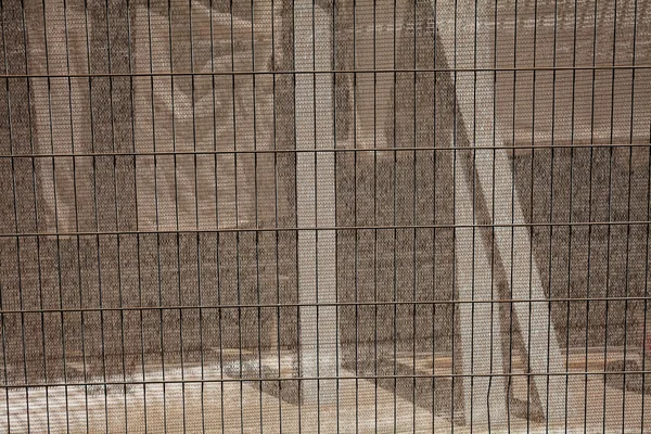 protective awnings from the tiny plastic network and hollow metal fences, note shallow depth of field