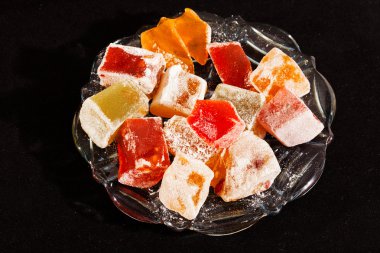 Türkçe zevklerin çeşitliliği, cam kasede servis ediliyor, siyah arka planda izole edilmiş.