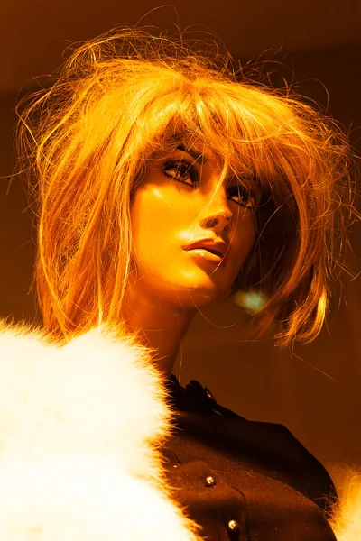 Closeup of mannequin head with messy wig