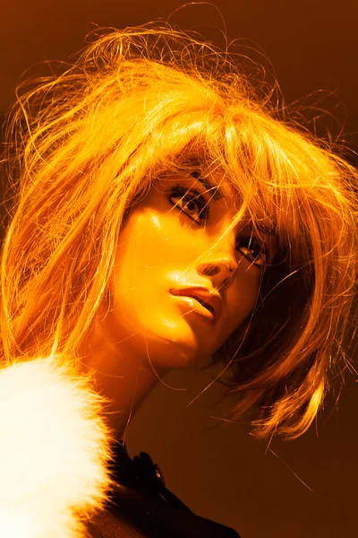 Closeup of mannequin head with messy wig