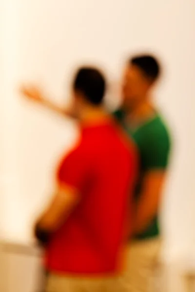 Blur of a two men talking; blurred 100%