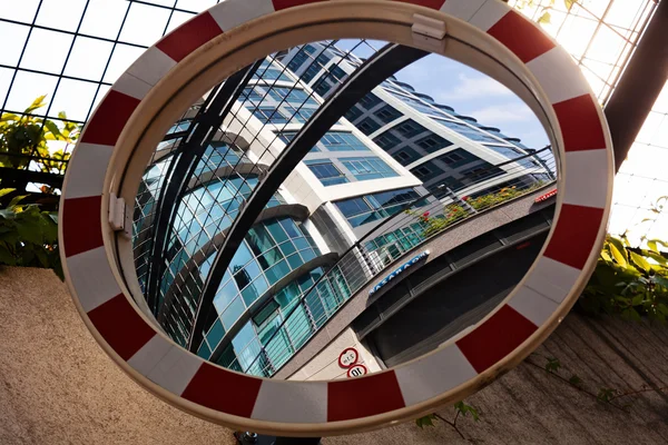 Closeup of a convex mirror reflecting the building