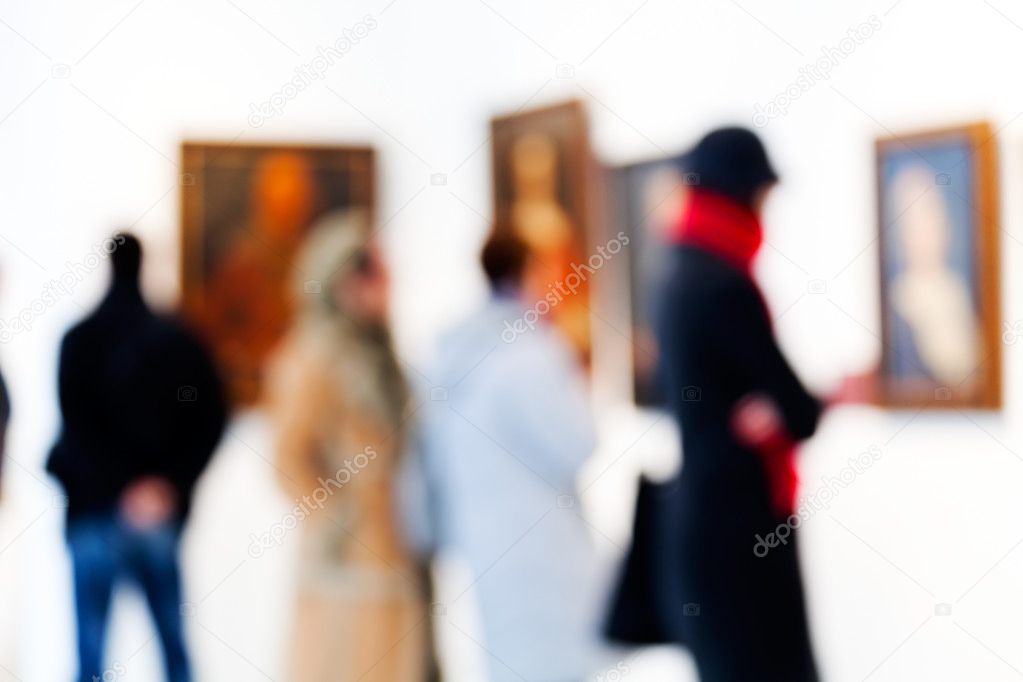 People are looking paintings in art gallery; blurred 100%