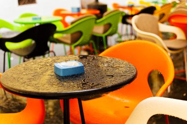 Mavi kültablası, boş tabloları ve arka planda koltukları olan ıslak masa; alanın sığ derinliğine dikkat edin