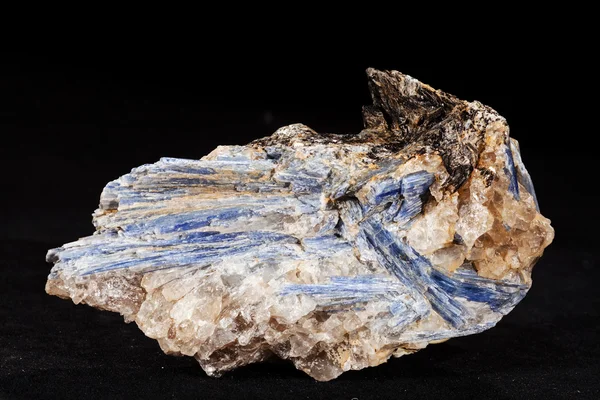  kyanite mineral with garnets on the black  background