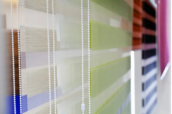 Samples of blinds and curtains for the windows with mehanism, note shallow depth of field