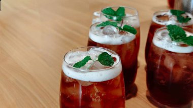 Taze nane yaprağı ve buz küpleriyle taze buzlu çay, yiyecek, içecek ve ticari yaşam tarzı için mükemmel bir yaz soğuk içecek konsepti..