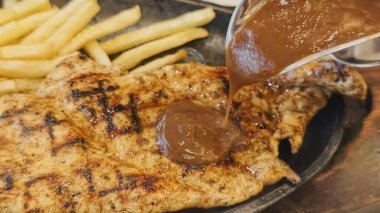 Kızarmış patates kızartması ve renkli taze sebzelerle servis edilen sulu ızgara tavuk bifteği restoran menüsü, yemek reklamı ve ticari mutfak içeriği için mükemmel.