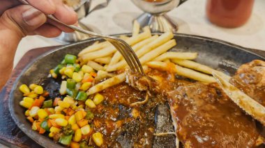 Kızarmış patates kızartması ve renkli taze sebzelerle servis edilen sulu ızgara tavuk bifteği restoran menüsü, yemek reklamı ve ticari mutfak içeriği için mükemmel.