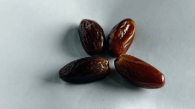 Taze tarihler, sağlıklı doğal çerez konsepti için beyaz arka planda izole edilmiş beyaz meyveler, parlak dokular ve gıda reklamları için mükemmel kahverengi renkler, beslenme içeriği ve ticari kullanım için mükemmel..