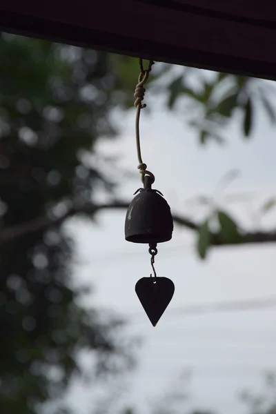 Hand bell in back light. — Stock Photo, Image