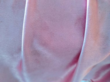 Yumuşak kıvrımlı zarif pembe saten kumaş ve ince bir parıltı. Yüksek çözünürlüklü dokuma deseni, lüks, moda veya düğün geçmişi için mükemmel..