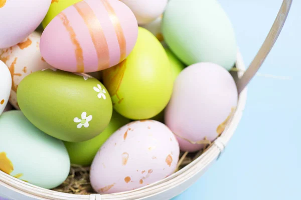 Easter basket filled with painted Easter eggs. Colorful painted Easter eggs in basket.