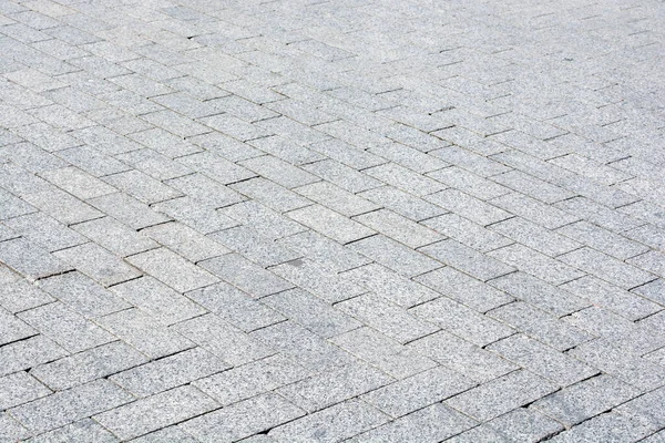 A large area, laid out of paving stone. Background texture relief.