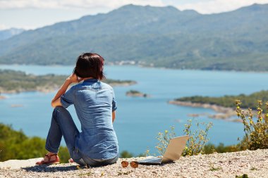 Güzel genç freelancer kadın lak oturan dizüstü bilgisayar kullanarak