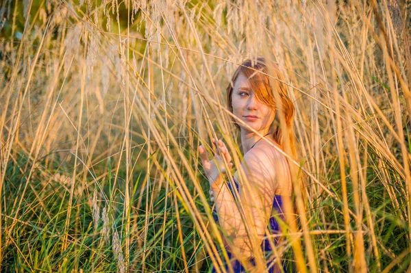 La fille parmi les hautes herbes séchées — Photo