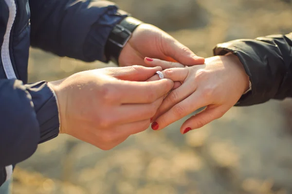 El hombre lleva un anillo de bodas en la mano de la mujer — Foto de Stock