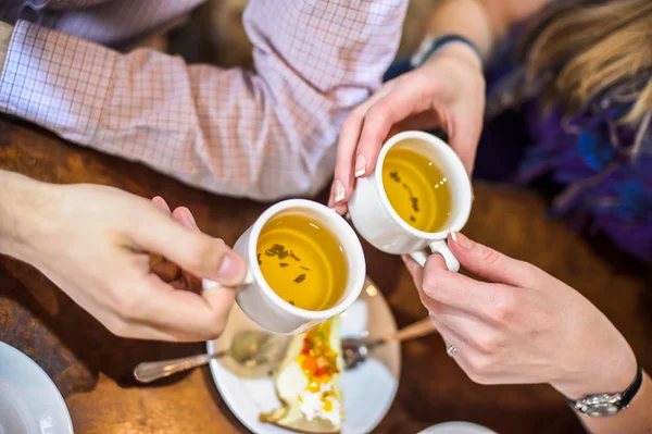 Arms. Man and woman drinking green tea — Stock Photo, Image