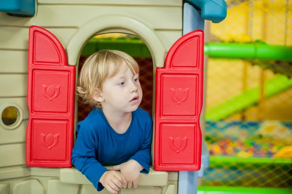 stock image Toddler boy looks out of the house