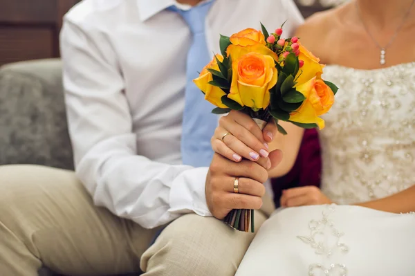 Bride and groom are holding bridal bouquet — Stock Photo, Image