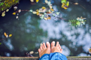 Su birikintisi arka planda kadın ayakları