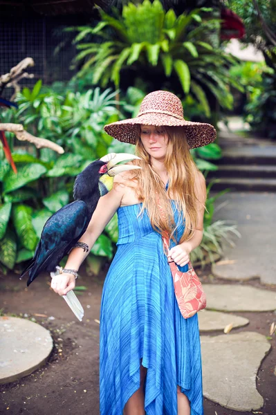 Woman in a tropical jungle with tropical bird on the hand in Bali — Stock Photo, Image