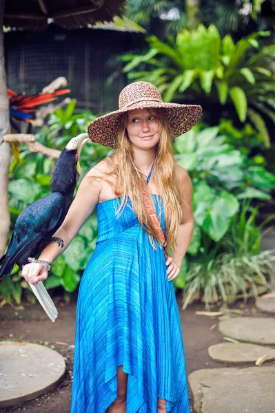 Woman in a tropical jungle with tropical bird on the hand in Bali — Stock Photo, Image