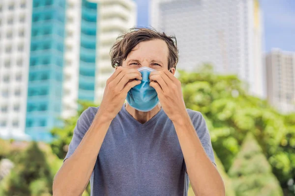 Improper wearing of mask concept. Man scratching his nose under the mask, touches the mask — Stock Photo, Image