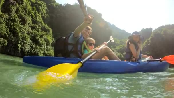 Scatto al rallentatore di una felice famiglia di turisti in kayak tra scogliere calcaree in un parco nazionale di Halong Bay, Vietnam. Viaggiare in Vietnam concetto — Video Stock