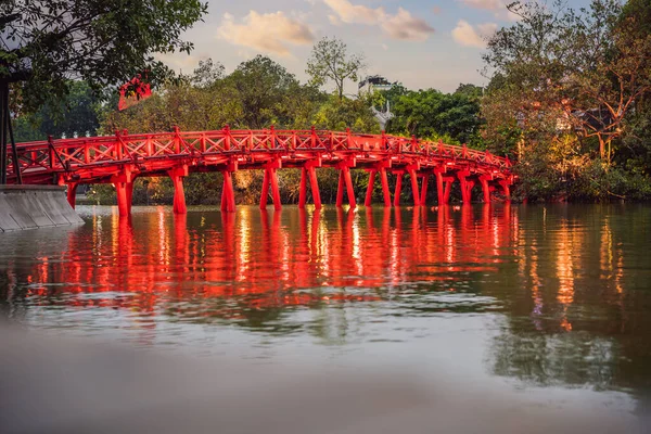 Hanoi Red Bridge at night. The wooden red-painted bridge over the Hoan Kiem Lake connects the shore and the Jade Island on which Ngoc Son Temple stands