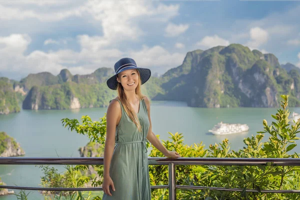 Attractive woman in a dress is traveling in Halong Bay. Vietnam. Travel to Asia, happiness emotion, summer holiday concept. Picturesque sea landscape. Ha Long Bay, Vietnam