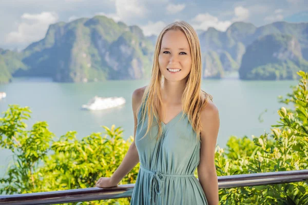 Attractive woman in a dress is traveling in Halong Bay. Vietnam. Travel to Asia, happiness emotion, summer holiday concept. Picturesque sea landscape. Ha Long Bay, Vietnam