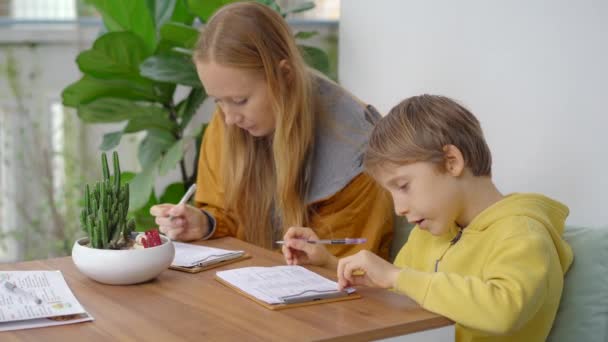 Mladá žena a její syn povečeří v krásné kavárně, kde se podávají misky. Vybírají ingredience pro jejich šťouchnutí — Stock video