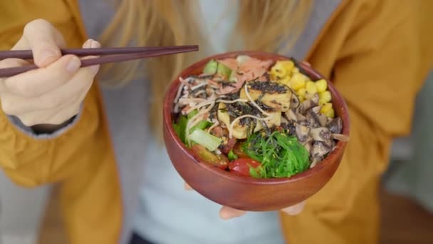 Une jeune femme profite de son dîner dans un beau café où sont servis des bols à poke. Rapide et sain. Concept alimentaire tendance — Video