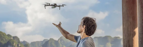 BANNER, LONG FORMAT Man controls a drone in Halong Bay. Vietnam. Travel to Asia, happiness emotion, summer holiday concept. Picturesque sea landscape. Ha Long Bay, Vietnam