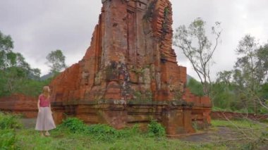 Genç bir kadın turist, Vietnam 'daki antik bir Cham medeniyetinin kalıntıları olan Oğlum Sığınağı' ndaki harabelerde yürüyor. Danang şehrindeki turizm beldesi. Vietnam 'a seyahat